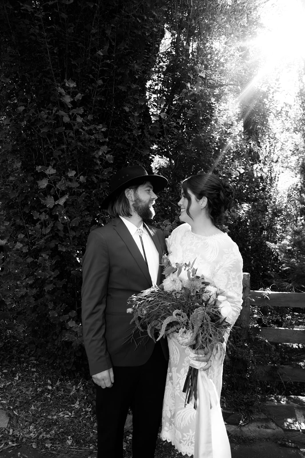 Black and white photo of Lana and Todd close together among the trees
